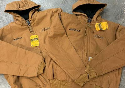 Brown hooded Carhartt style work jackets with embroidered chest logos by 400 Ink