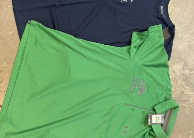 Navy and green branded shirts with embroidered and printed logos by 400 Ink
