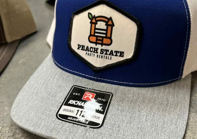Blue, white and gray Richardson trucker hat with sublimated patch by 400 Ink