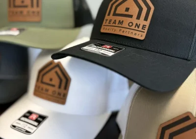 Assorted trucker hats with leather logo patches by 400 Ink