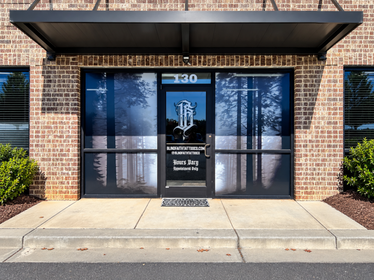 Blind Faith Tattoo Co storefront window graphics with logo and hours by 400 Ink in Dawsonville GA