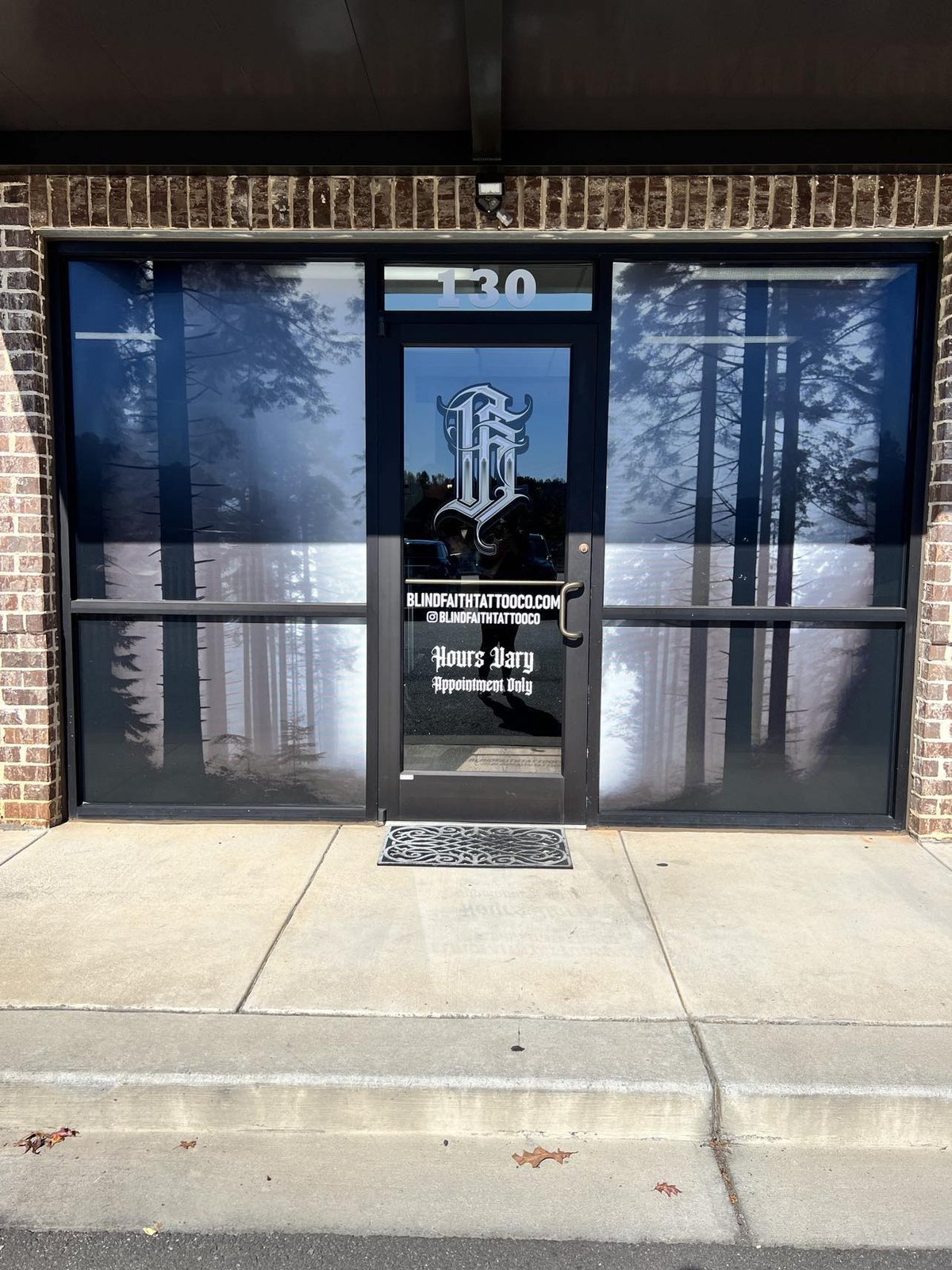 Storefront window graphics with logo and business hours by 400 Ink